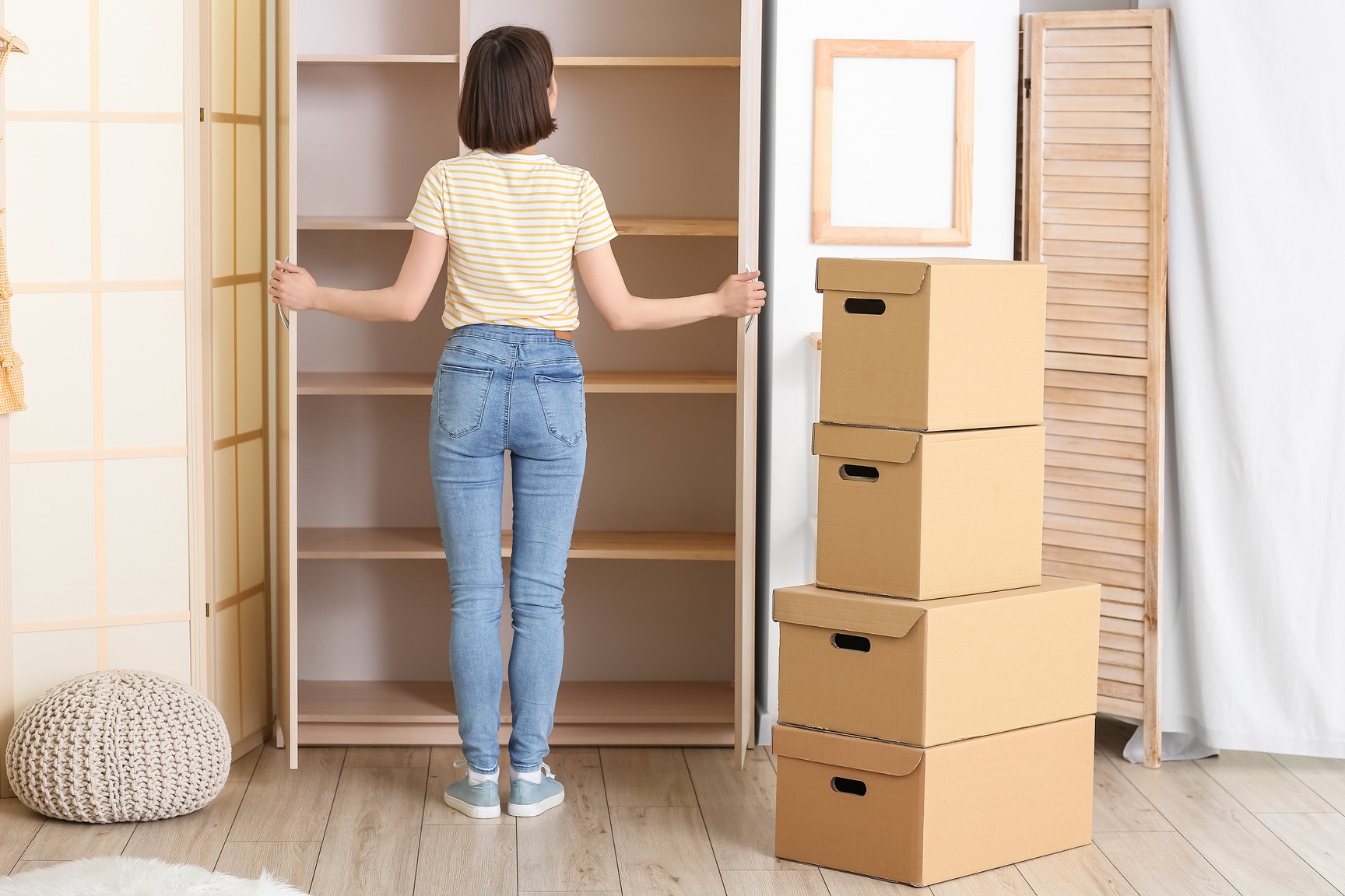 Young Woman near Empty Wardrobe at Home