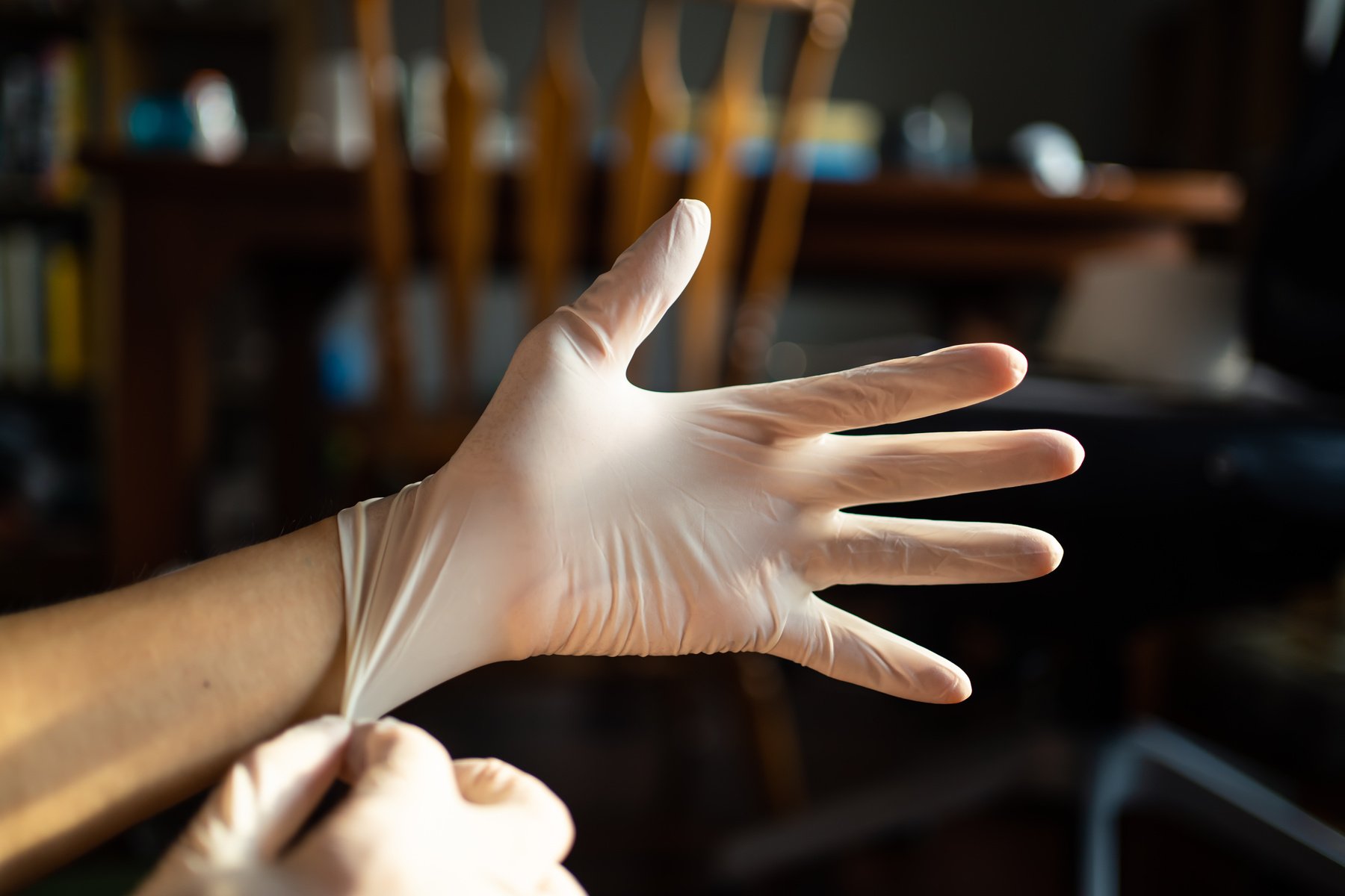 wearing disposable latex gloves